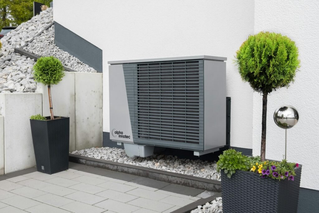 pexels-alpha-innotec-936418931-20046694 a picture of an HVAC unit outside of a modern looking white house.