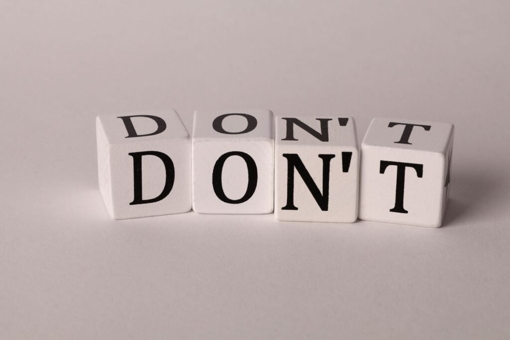 Text cubes spelling 'DON'T' on a clean white background, ideal for concepts of caution or prohibition.